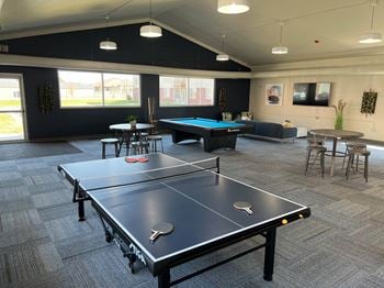 A games room with a ping pong table and a foosball table